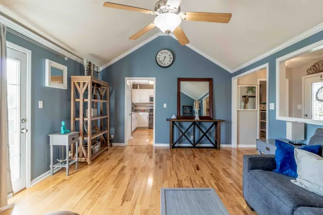 a view of living room kitchen with furniture and wooden floor