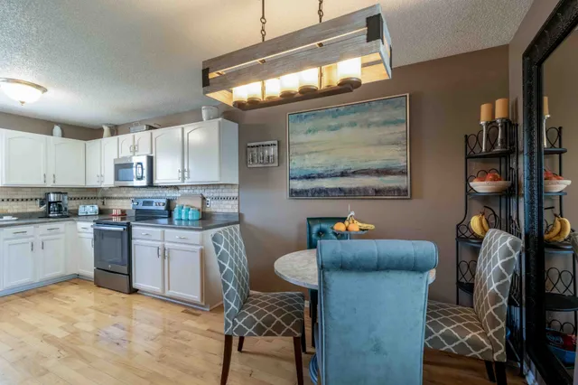 a kitchen with stainless steel appliances a stove a sink dishwasher and cabinets