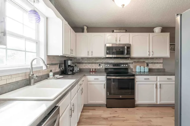 a kitchen with a sink stove and cabinets