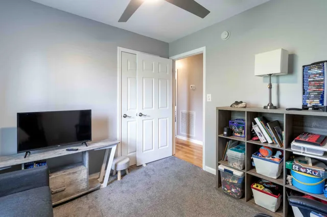 a view of a livingroom with furniture and a flat screen tv