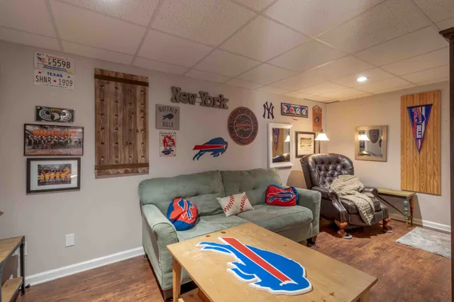 a living room with lots of furniture and painting on the wall