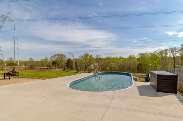 a view of swimming pool with seating area and barbeque oven