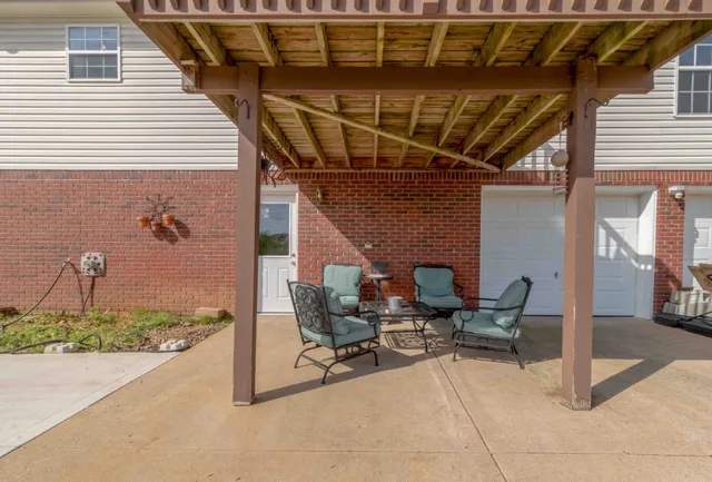 a view of a patio with table and chairs