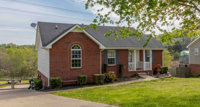 a view of a house with a yard patio and a yard