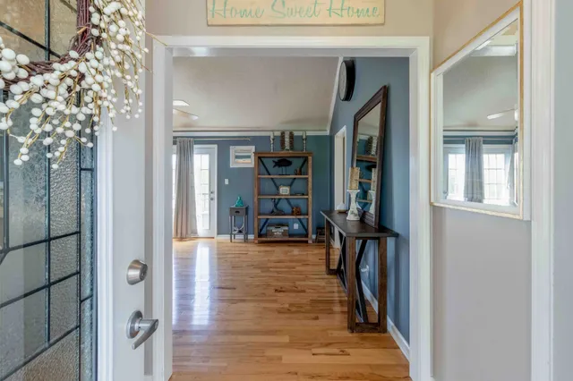 a view of a livingroom with wooden floor and a staircase