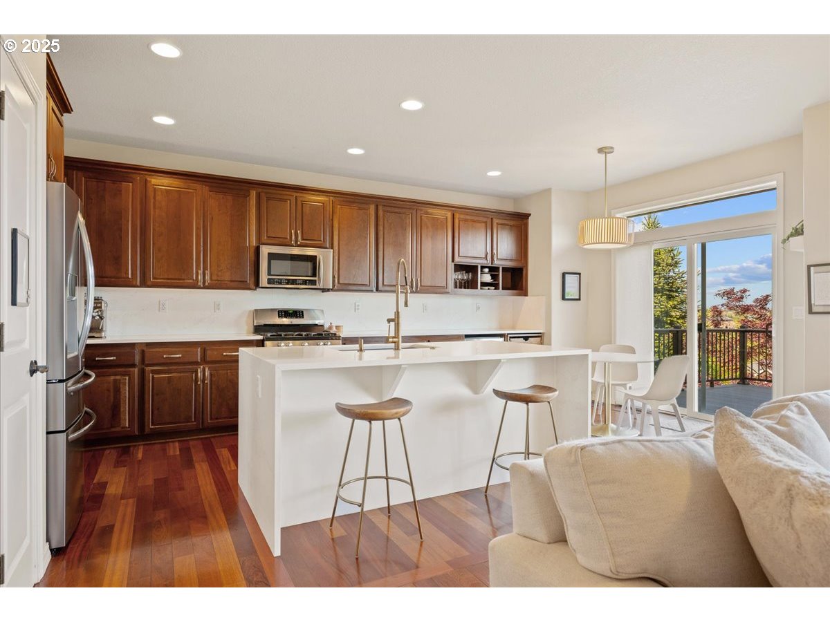 5254 Wedgewood Loop Newberg, OR 97132 - Photo 11 of 43 a kitchen with stainless steel appliances kitchen island granite countertop a stove a sink a refrigerator and a microwave