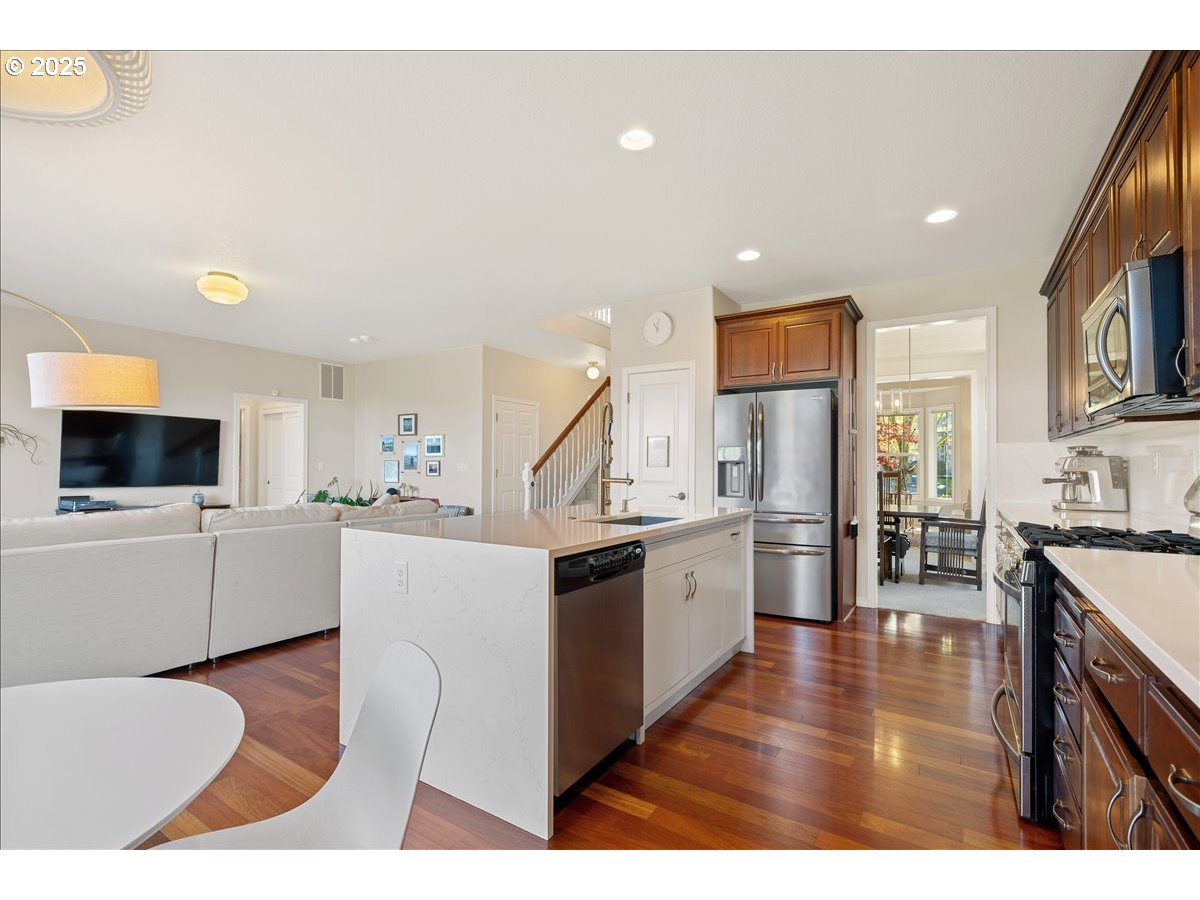5254 Wedgewood Loop Newberg, OR 97132 - Photo 12 of 43 a kitchen with stainless steel appliances a stove top oven a sink a refrigerator and cabinets