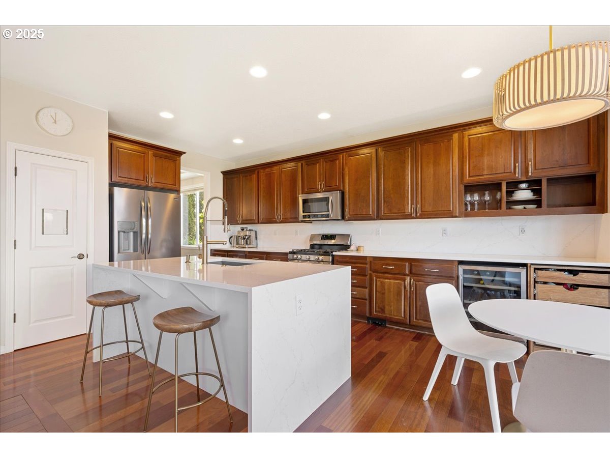5254 Wedgewood Loop Newberg, OR 97132 - Photo 13 of 43 a kitchen with a table chairs microwave and cabinets
