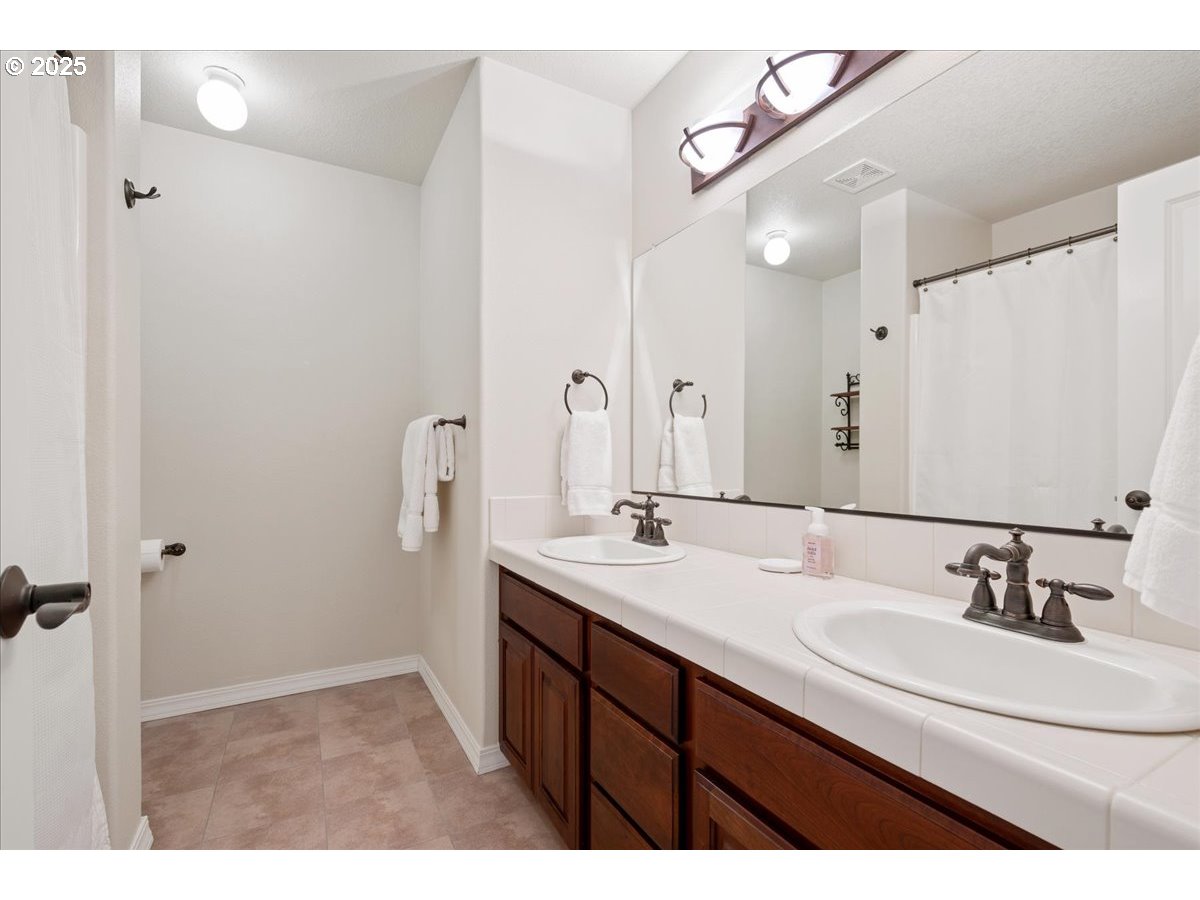 5254 Wedgewood Loop Newberg, OR 97132 - Photo 28 of 43 a bathroom with a sink double vanity and a mirror