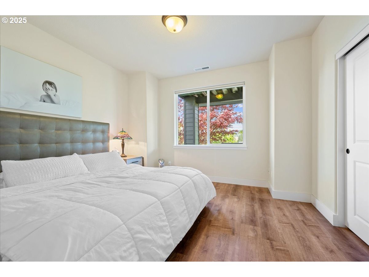 5254 Wedgewood Loop Newberg, OR 97132 - Photo 33 of 43 a bedroom with a bed and a painting on the wall