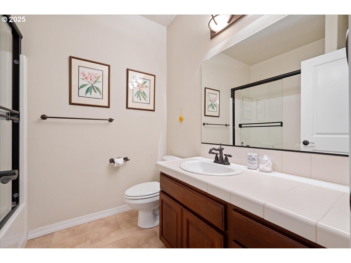 5254 Wedgewood Loop Newberg, OR 97132 - Photo 34 of 43 a bathroom with a sink a toilet and mirror