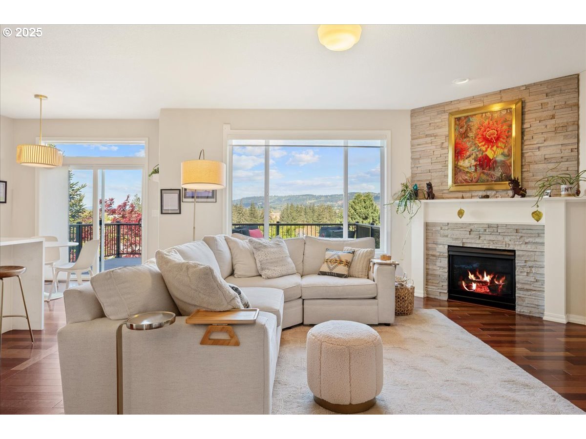 5254 Wedgewood Loop Newberg, OR 97132 - Photo 5 of 43 a living room with furniture a flat screen tv and a fireplace
