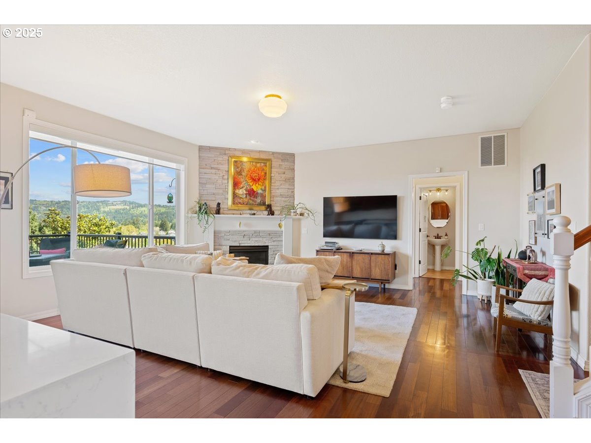 5254 Wedgewood Loop Newberg, OR 97132 - Photo 10 of 43 a living room with furniture a flat screen tv and a fireplace