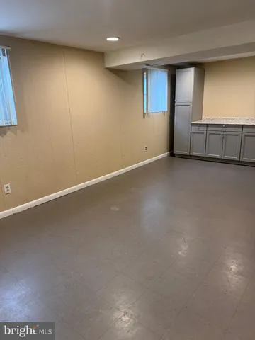 a view of a kitchen with white cabinets