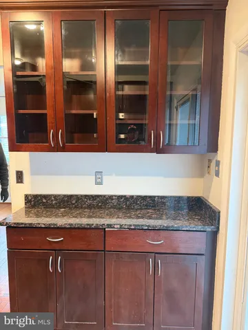 a kitchen with granite countertop a sink and cabinets