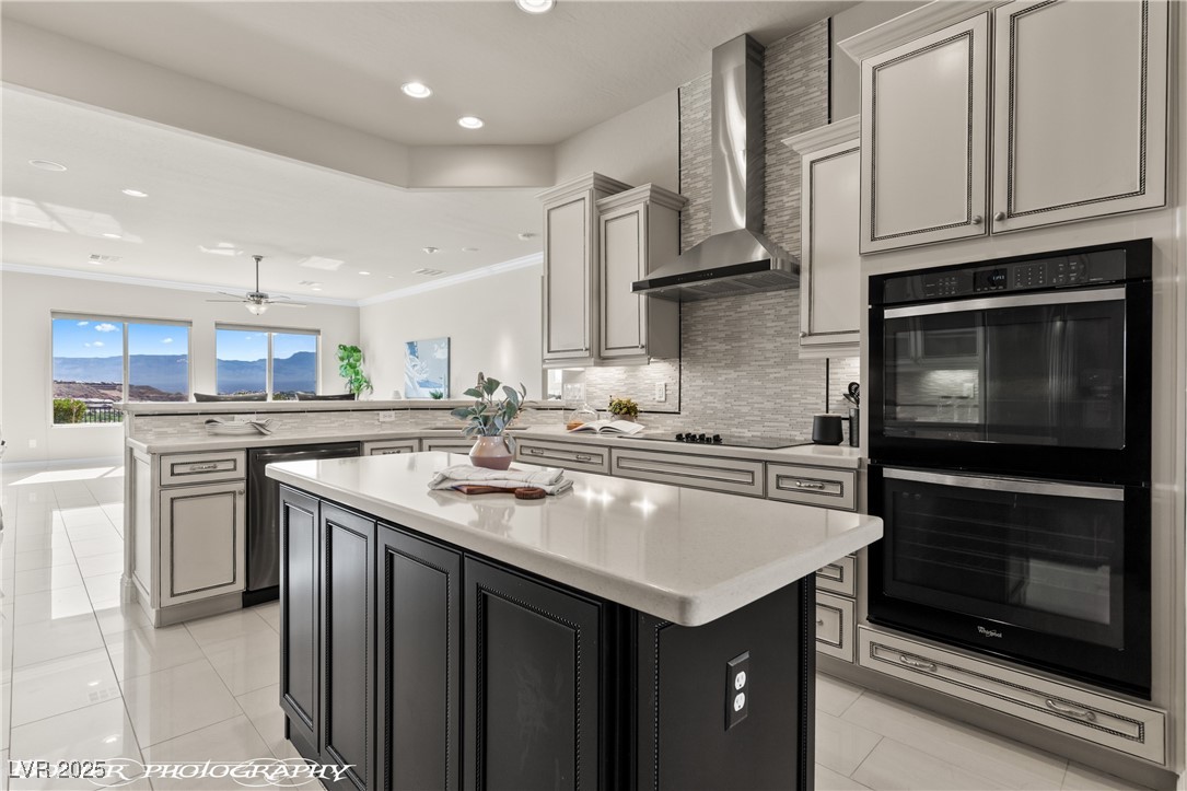 1348 Basin View Mesquite, NV 89034 - Photo 18 of 70 Kitchen with a center island, decorative backsplash, a peninsula, recessed lighting, and wall chimney exhaust hood