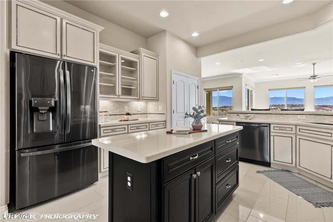 1348 Basin View Mesquite, NV 89034 - Photo 19 of 70 Kitchen featuring dark cabinetry, stainless steel appliances, glass insert cabinets, a kitchen island, and recessed lighting