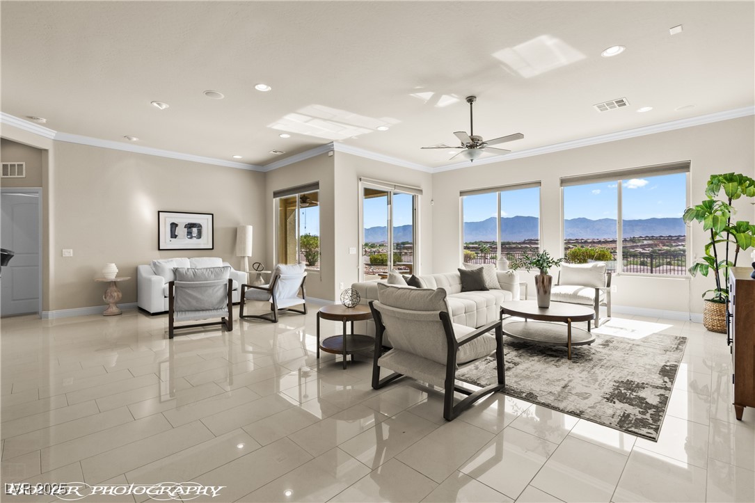 1348 Basin View Mesquite, NV 89034 - Photo 2 of 70 Living area with ornamental molding, a mountain view, recessed lighting, healthy amount of natural light, and a ceiling fan