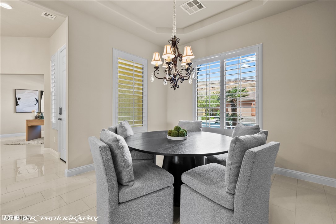 1348 Basin View Mesquite, NV 89034 - Photo 24 of 70 Dining area featuring light tile patterned flooring and a chandelier