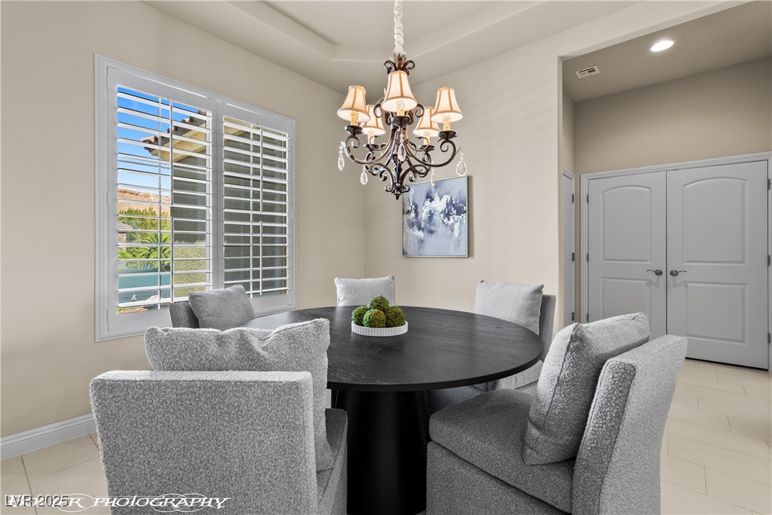 1348 Basin View Mesquite, NV 89034 - Photo 25 of 70 Dining area with light tile patterned floors and a chandelier