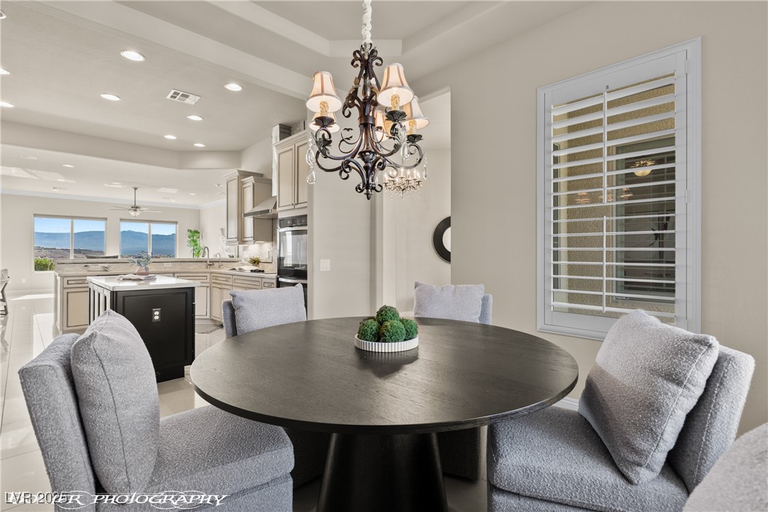 1348 Basin View Mesquite, NV 89034 - Photo 26 of 70 Dining room featuring recessed lighting, a chandelier, light tile patterned floors, and a raised ceiling