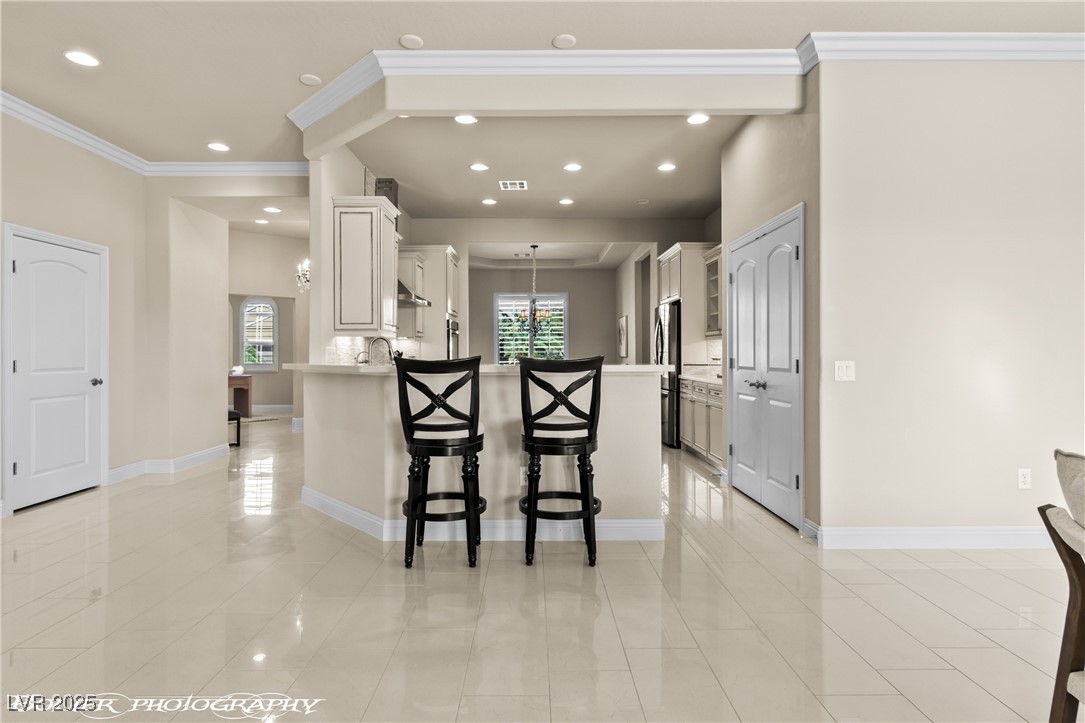 1348 Basin View Mesquite, NV 89034 - Photo 28 of 70 Kitchen featuring a kitchen bar, white cabinets, a peninsula, recessed lighting, and pendant lighting