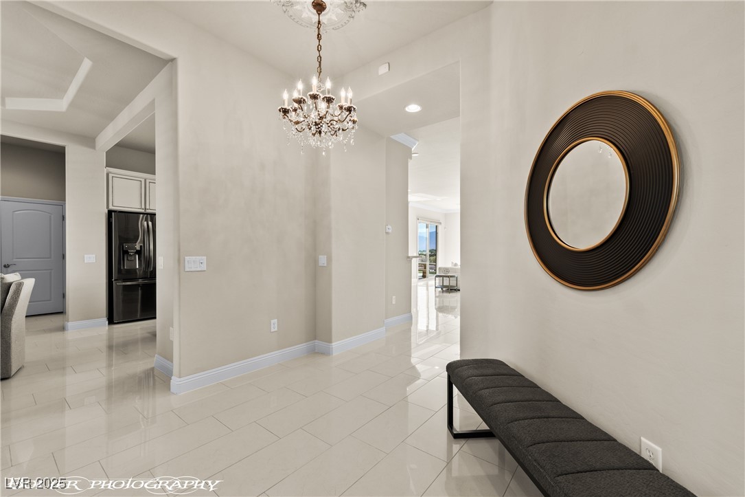 1348 Basin View Mesquite, NV 89034 - Photo 32 of 70 Corridor with light tile patterned floors, a chandelier, and recessed lighting
