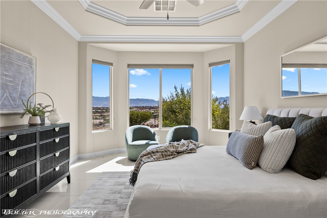 1348 Basin View Mesquite, NV 89034 - Photo 35 of 70 Tiled bedroom featuring ornamental molding, multiple windows, a ceiling fan, and a mountain view
