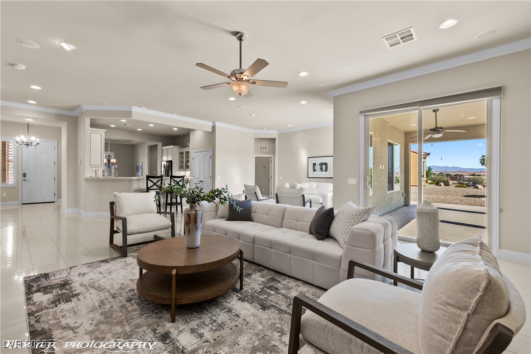 1348 Basin View Mesquite, NV 89034 - Photo 4 of 70 Living area featuring ceiling fan, light tile patterned floors, crown molding, recessed lighting, and a chandelier