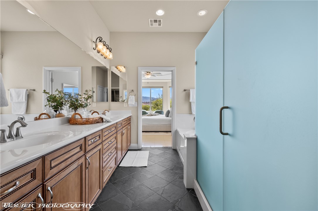 1348 Basin View Mesquite, NV 89034 - Photo 41 of 70 Ensuite bathroom featuring double vanity, recessed lighting, and a shower stall
