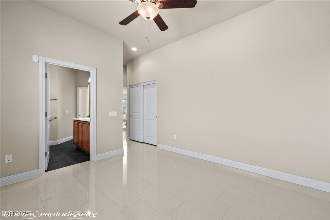 1348 Basin View Mesquite, NV 89034 - Photo 43 of 70 Unfurnished bedroom featuring light tile patterned flooring, ceiling fan, a closet, connected bathroom, and recessed lighting