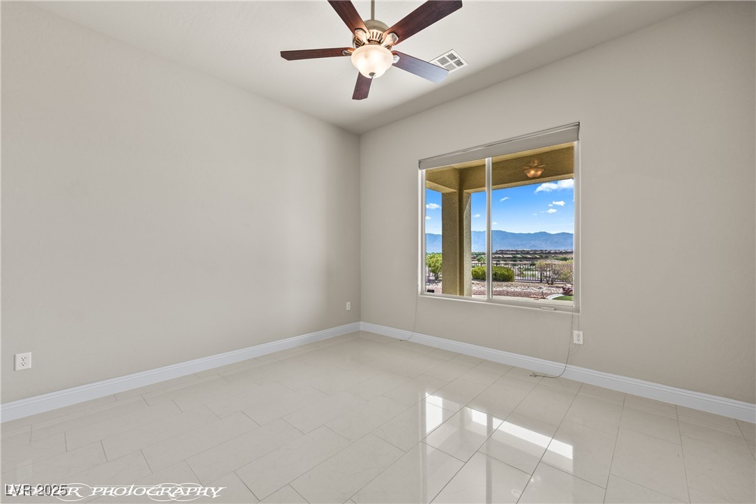 1348 Basin View Mesquite, NV 89034 - Photo 46 of 70 Unfurnished room featuring a mountain view, a ceiling fan, and light tile patterned floors