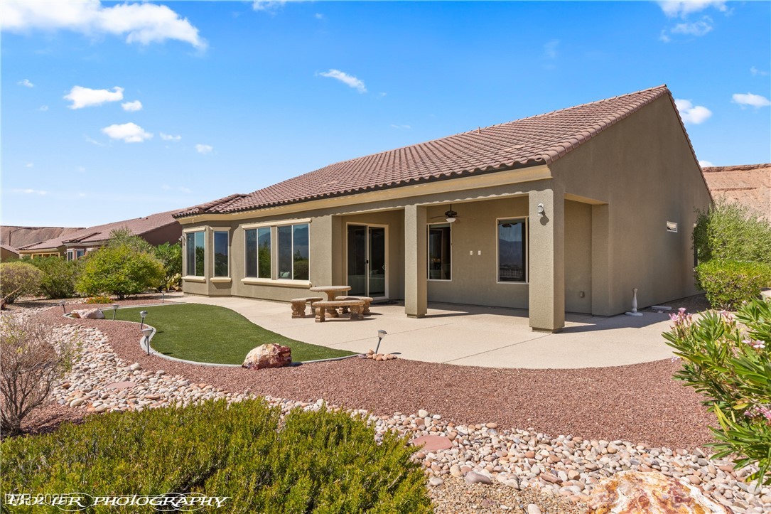 1348 Basin View Mesquite, NV 89034 - Photo 59 of 70 Back of house featuring stucco siding, a patio area, a tiled roof, and a ceiling fan