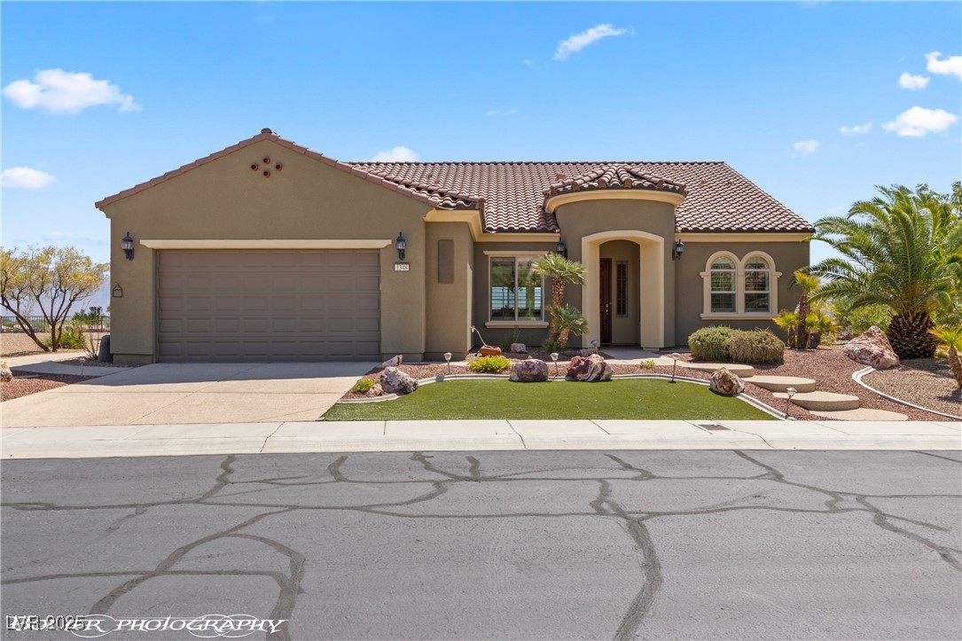 1348 Basin View Mesquite, NV 89034 - Photo 62 of 70 Mediterranean / spanish home featuring stucco siding, an attached garage, concrete driveway, and a tiled roof