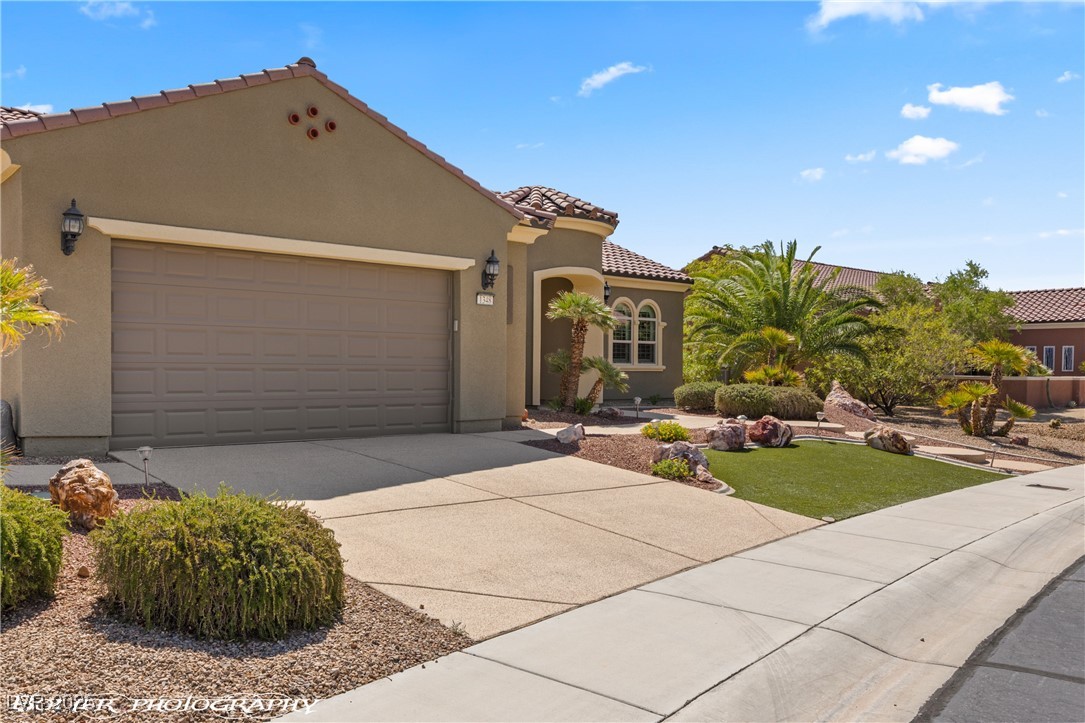 1348 Basin View Mesquite, NV 89034 - Photo 64 of 70 Mediterranean / spanish-style house with driveway, a tiled roof, a garage, and stucco siding