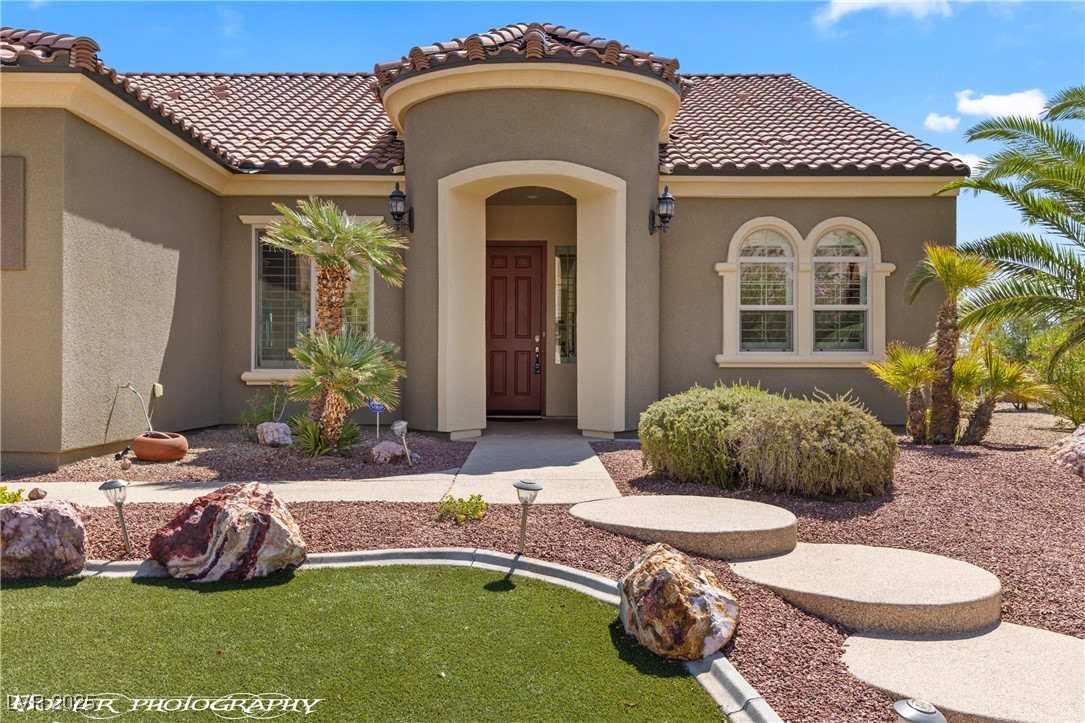 1348 Basin View Mesquite, NV 89034 - Photo 65 of 70 View of exterior entry featuring stucco siding and a tiled roof