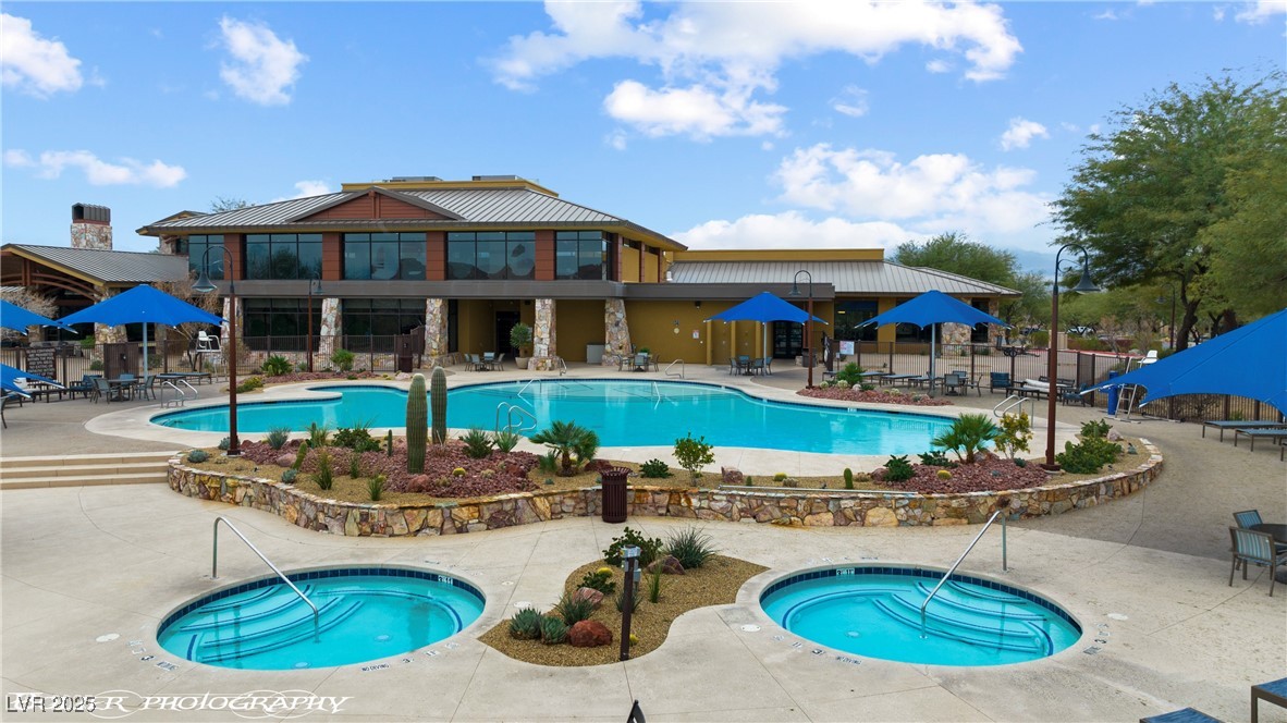 1348 Basin View Mesquite, NV 89034 - Photo 66 of 70 Community pool with a hot tub and a patio area