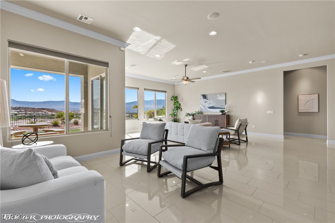 1348 Basin View Mesquite, NV 89034 - Photo 9 of 70 Living area featuring crown molding, a mountain view, recessed lighting, light tile patterned floors, and ceiling fan