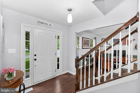 a view of entryway with wooden floor and stairs