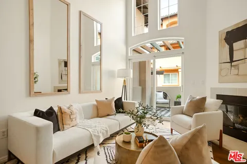a living room with furniture and paintings on the wall