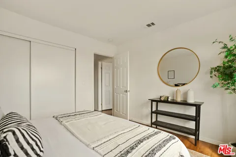 a bedroom with a bed and a potted plant