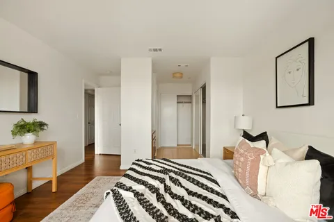 a bedroom with a bed and a couch