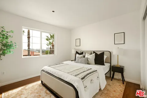 a bedroom with a bed and a night stand