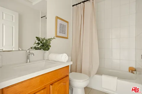 a bedroom with a bed and a potted plant