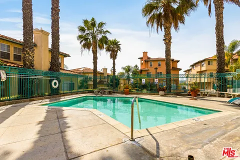 a view of a swimming pool with outdoor seating