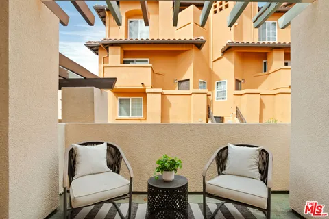 a view of a chair and table in the balcony