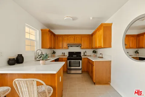 a kitchen with stainless steel appliances granite countertop a sink and a stove