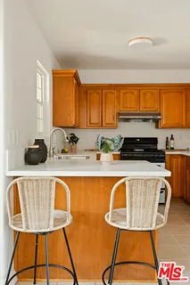 a kitchen with a sink a stove and a wooden cabinets
