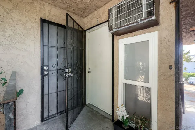 a brick house with tree in front of it