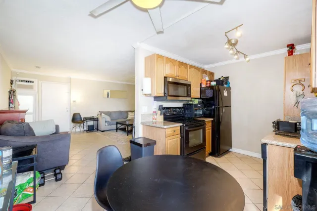 a kitchen with sink a counter top space appliances and cabinets